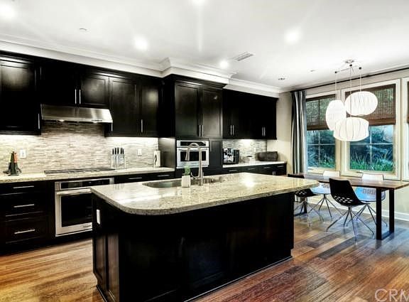 The home offers Sophisticated residential touches throughout including Emerald Exotics Bamboo Hardwood Flooring, Fitted Window Shades, Wooden Soft-Close Drawers and Built-Ins, and Solar Panels on a PRE-PAID Lease!