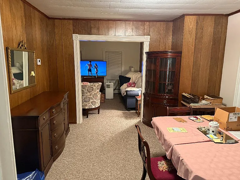 view of ding room into living room, paneling will be painted to off white