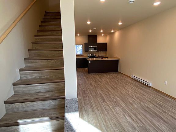 Stairs to bedroom, living on right