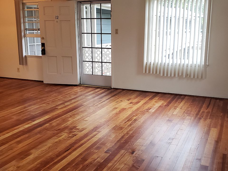 Newly refinished natural hardwood floors throughout