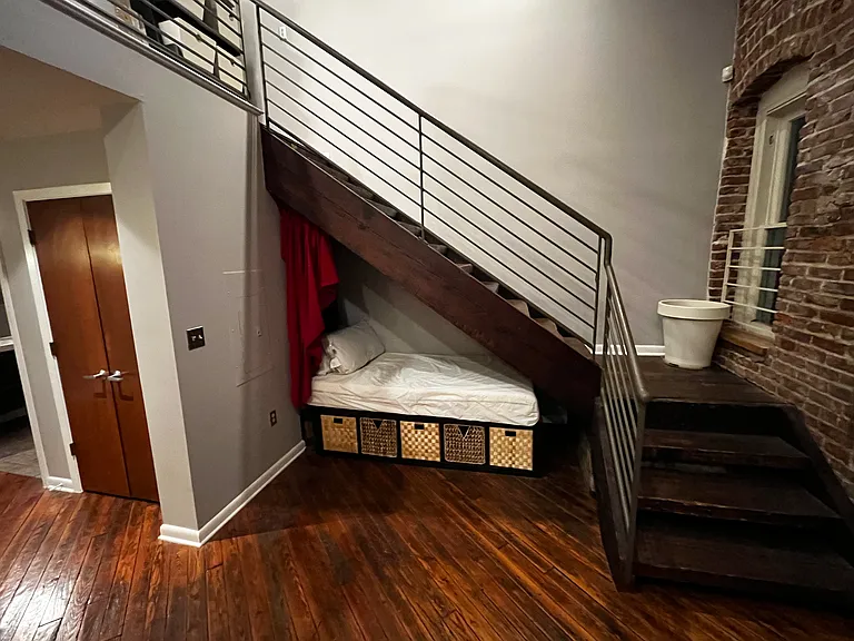 Additional sleeping (and storage) area under stairs.