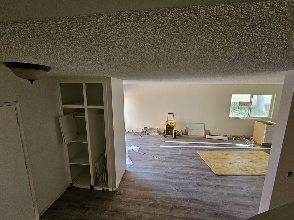 Downstairs. Open concept. Entry, dining & living rooms, kitchen, half bath. *Currently being remodeled*