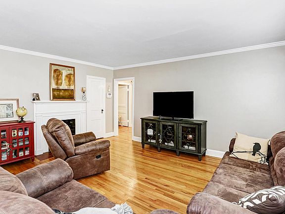Living room with hardwood floors and gas fire place.
