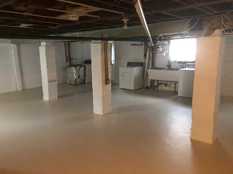 Lower Level, one open room with washer, dryer, utility tub, door to side yard
