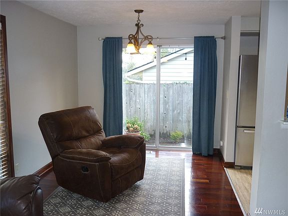 Dining room with slider to side patio also leads to backyard. 