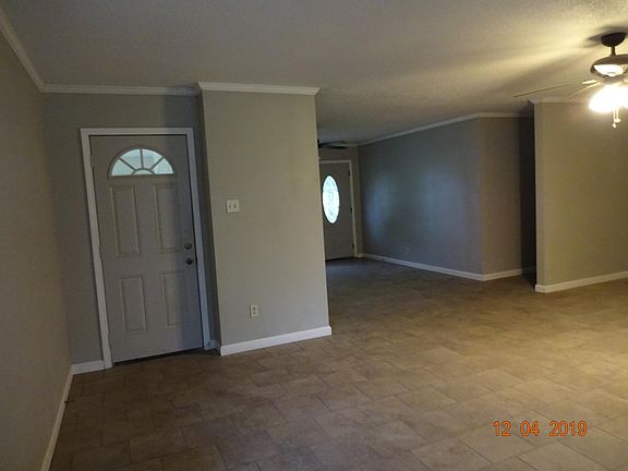 Door to carport as seen from the living room/den/dining room/kitchen