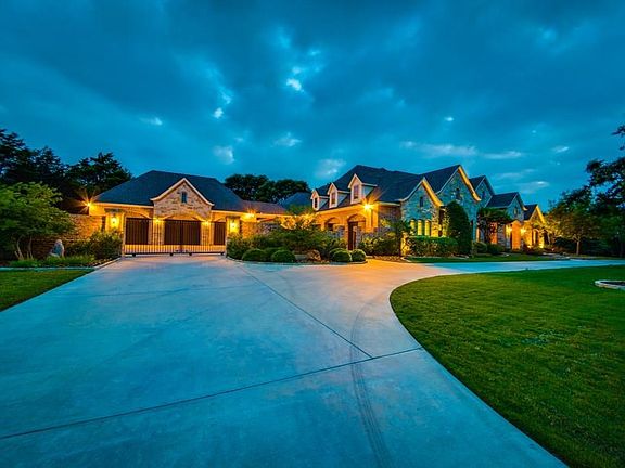 Exterior LED lighting, convenient circular drive, electric privacy gate leading to garages and motor court...turn key home!!!!