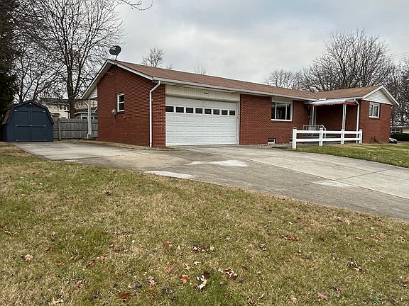 2 car garage, extra parking area and storage shed.