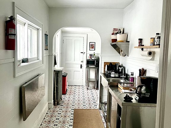 Galley kitchen with laundry room at the end to the right.