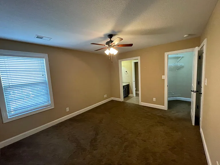 upstairs bedroom with personal sink and vanity, connected to jack and jill bath with walk in closet