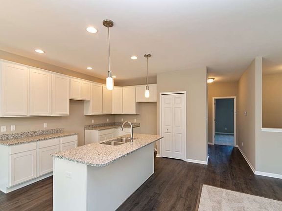 Beautiful, bright white kitchen with island overlooking great room.