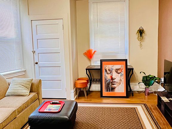 Spacious living room with hardwood floor, bay windows, closets and optional furniture