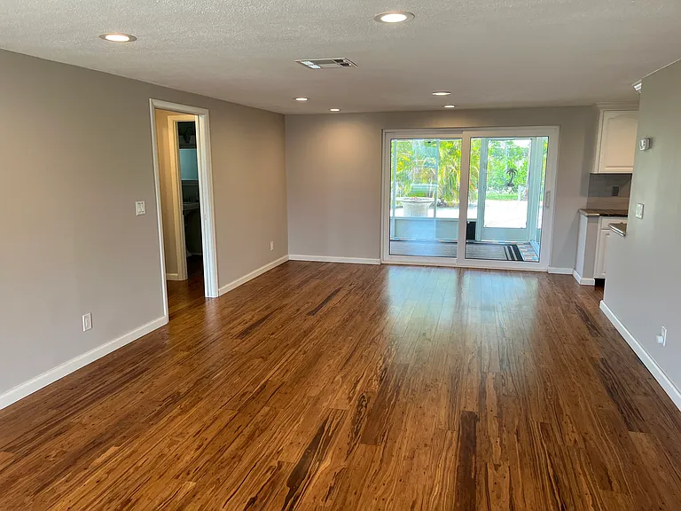 Living room with access to Lanai and kitchen