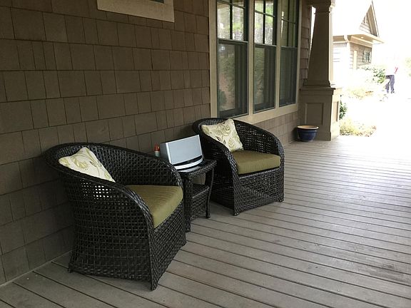 Serene front porch stretches full length of house.