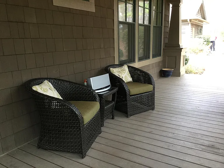 Serene front porch stretches full length of house.