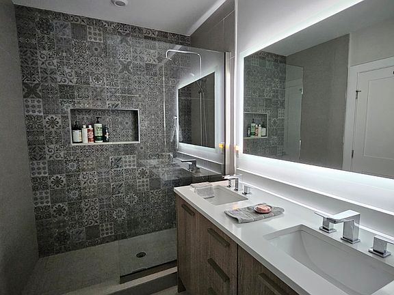 Master bathroom with stand-up shower and a large bathtub.