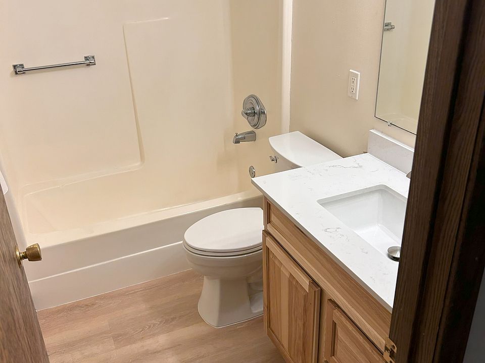 Newly installed flooring and bathroom vanity with plenty of storage.