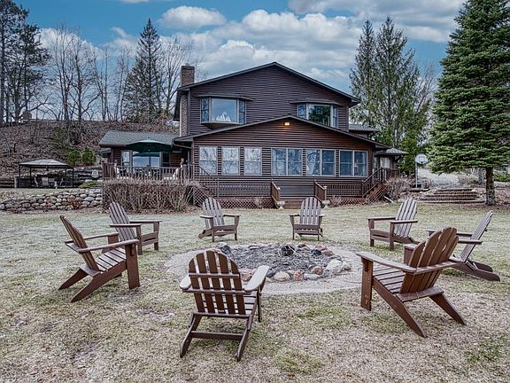 Home showing lakeside firepit