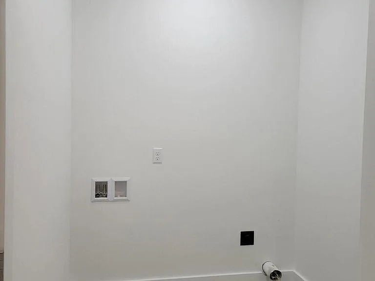 Downstairs laundry (off attached garage and kitchen). Washer & dryer provided but not shown.