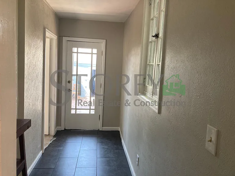 Hallway to main level bedroom and backyard