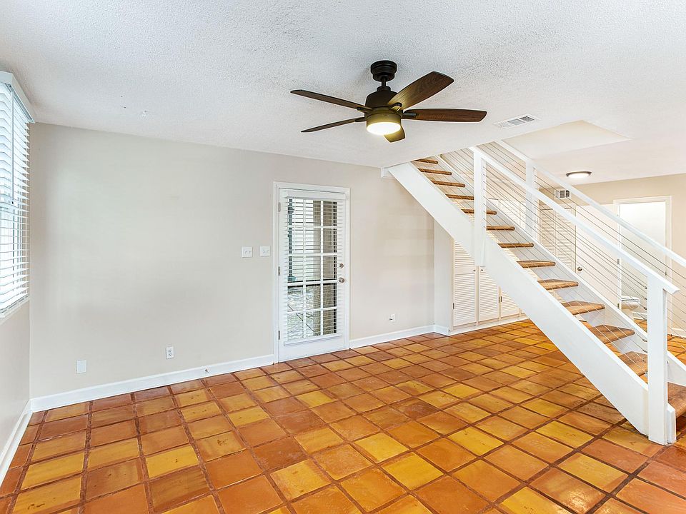 First floor includes an open floor plan with living area, full kitchen, storage closet, half bathroom, and shared courtyard access.