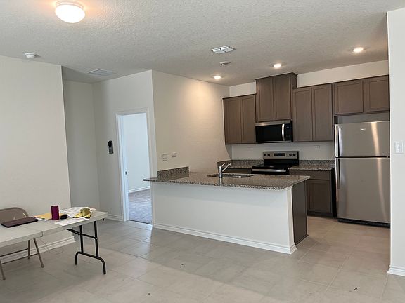 In the main living area looking across to the kitchen, master bedroom off to the left behind.