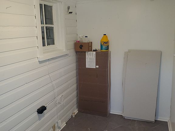 Back enclosed porch with dryer hookup.