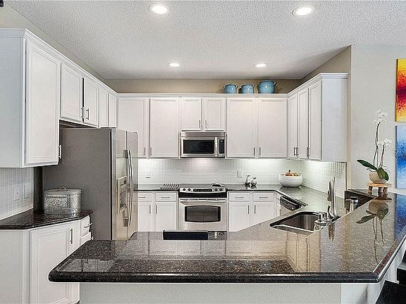 Kitchen with stainless steel appliances and granite countertop