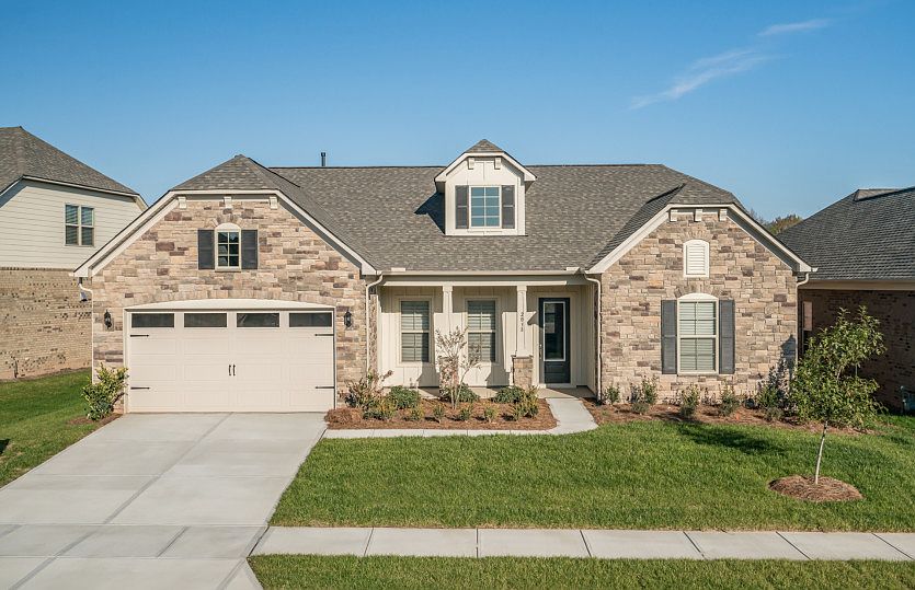 Tangerly Oak Exterior EC3S features stone, hardi board and covered front porch