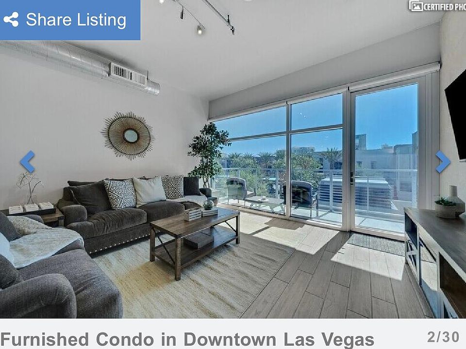 Semi-corner unit with a balcony overlooking the pool and skyline view of the Stratosphere hotel.
