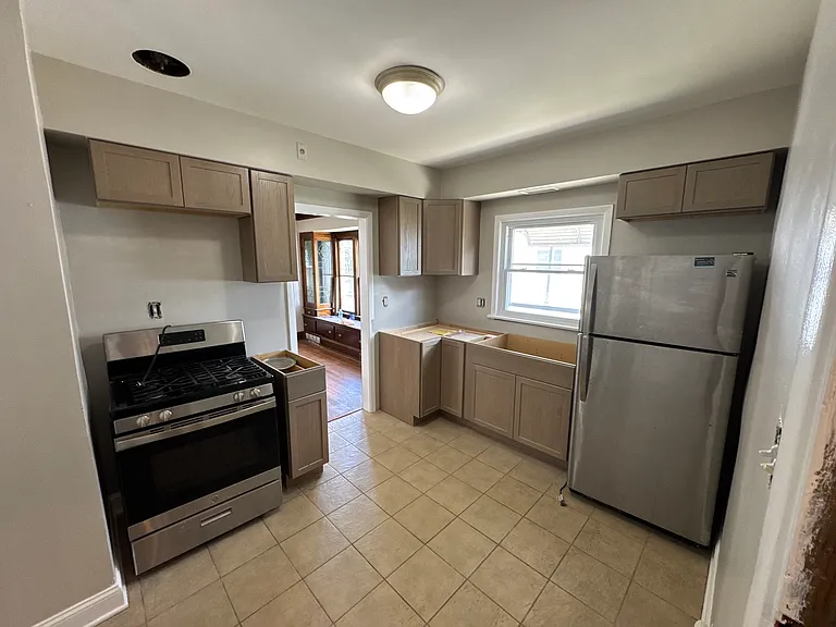 *Excuse our dust! This photo was taken during renovation. The kitchen will be fully completed before tours begin on Saturday, June 20, and will feature beautiful white quartz countertops, a classic white subway tile backsplash, and updated faucet.*