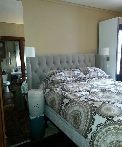 Large bedroom boasts en-suite bathroom with walk-in closet and additional mirrored wardrobes for ample storage.