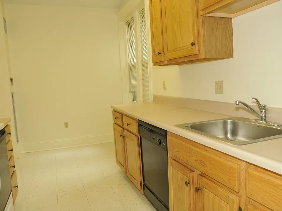 Efficient apartment kitchen featuring modern cabinetry and functional workspace