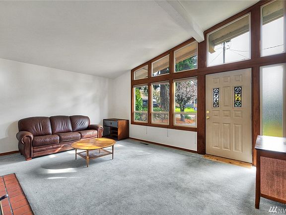 Wall of windows look out to gorgeous private yard!