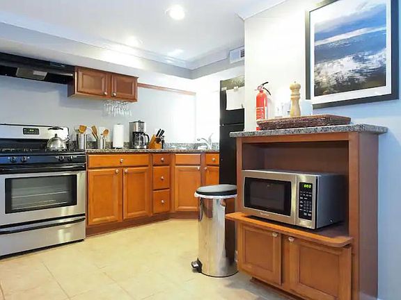 Renovated kitchen with granite countertops, tile floors, quality cabinets, and full size fridge, sink, stove, oven.