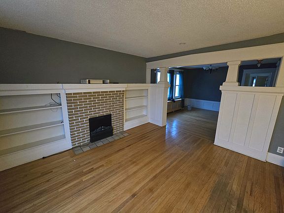 Living room with built-in shelving and electric fireplace heater