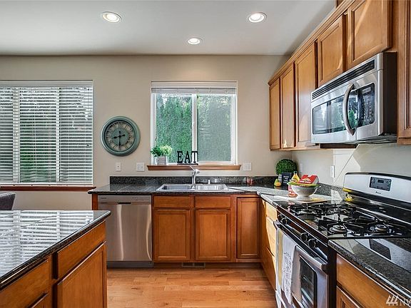 Dining area has plenty space for a six chair table and gorgeous hardwood flooring.