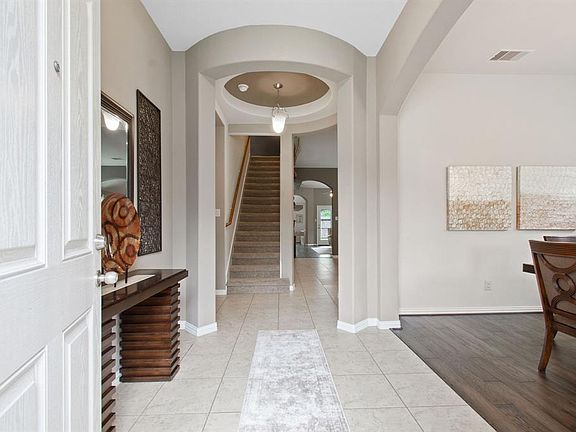 Upgraded large ceramic tile in welcoming entryway.