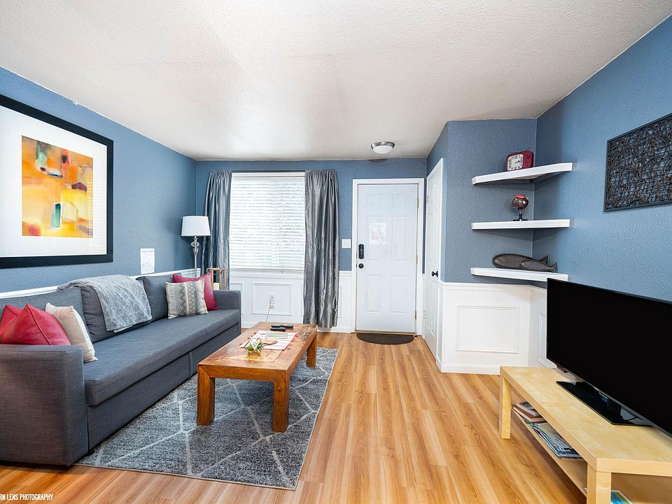 Main front room with queen size pull-out sleeper couch and smart TV