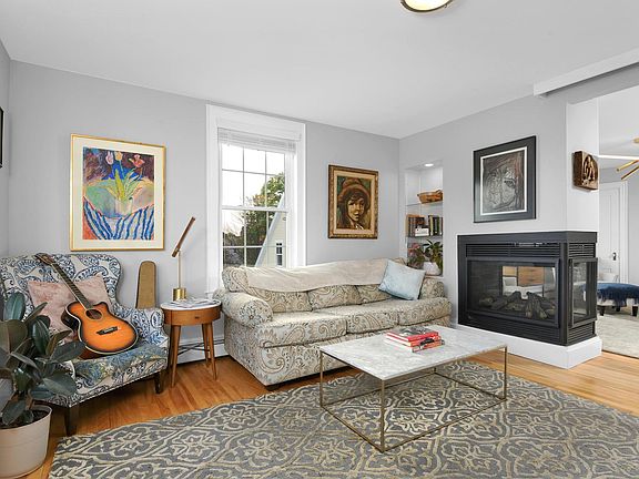 Living room - includes three-sided gas fireplace and large bay window overlooking expansive water views