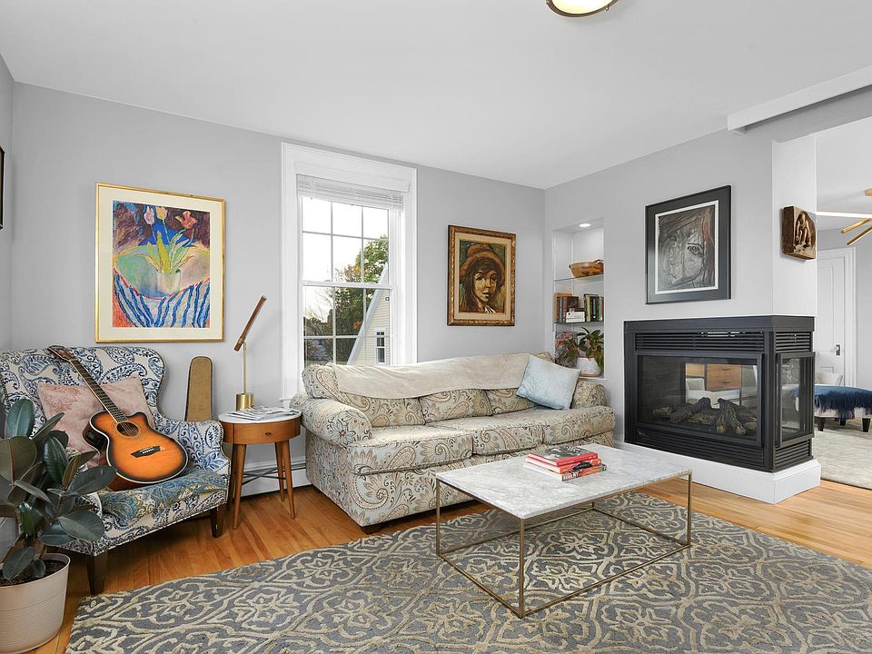 Living room - includes three-sided gas fireplace and large bay window overlooking expansive water views