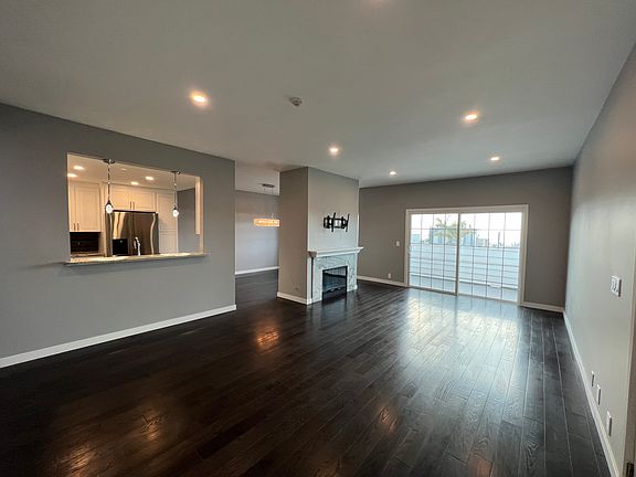 Living Room with stand alone gas fireplace.TV mount above fireplace included. New hardwood floors throughout.