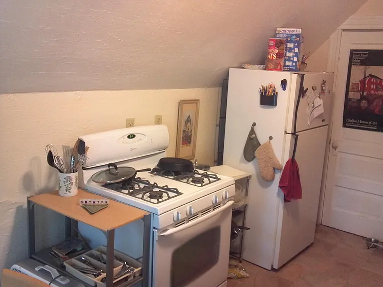 kitchen wall with refrigerator, gas stove. closet houses new gas furnace.