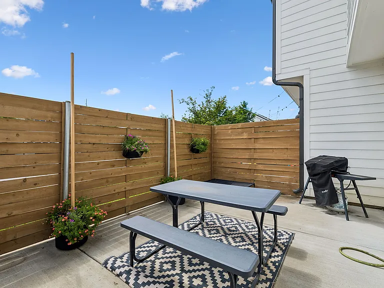 Private fenced backyard with patio, perfect for pets, grilling, and outdoor entertaining.