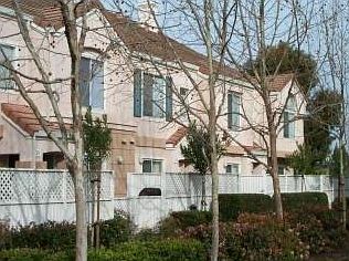 This townhome is located by a lovely grassy area with mature trees and well-landscaped garden.