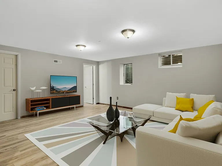 Virtually staged lower level family room demonstrating layout possibilities