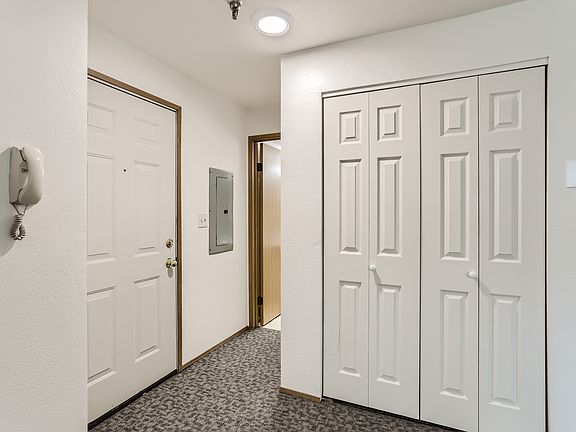 The door to the apartment is on the left. The closet where the stack washer/ dryer are located is on the right.
