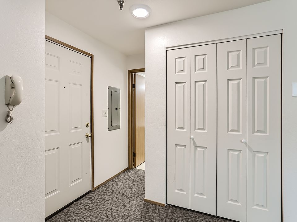 The door to the apartment is on the left. The closet where the stack washer/ dryer are located is on the right.