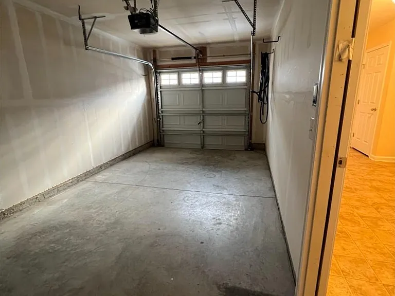 One car garage with additional parking space in the driveway