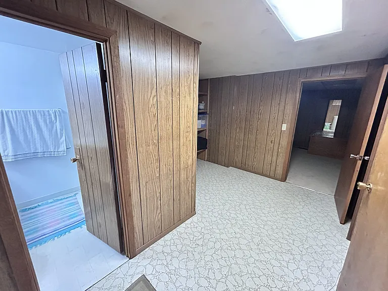 Basement hallway to bathroom and extra room